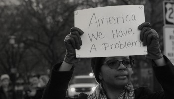 Black Woman Holding Protest Sign