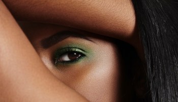 Close-up of woman's eye with green make up