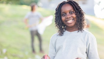 Beautiful African American girl helps with community cleanup