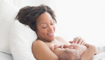 Mixed race mother nursing newborn baby