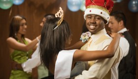 African prom king and queen dancing