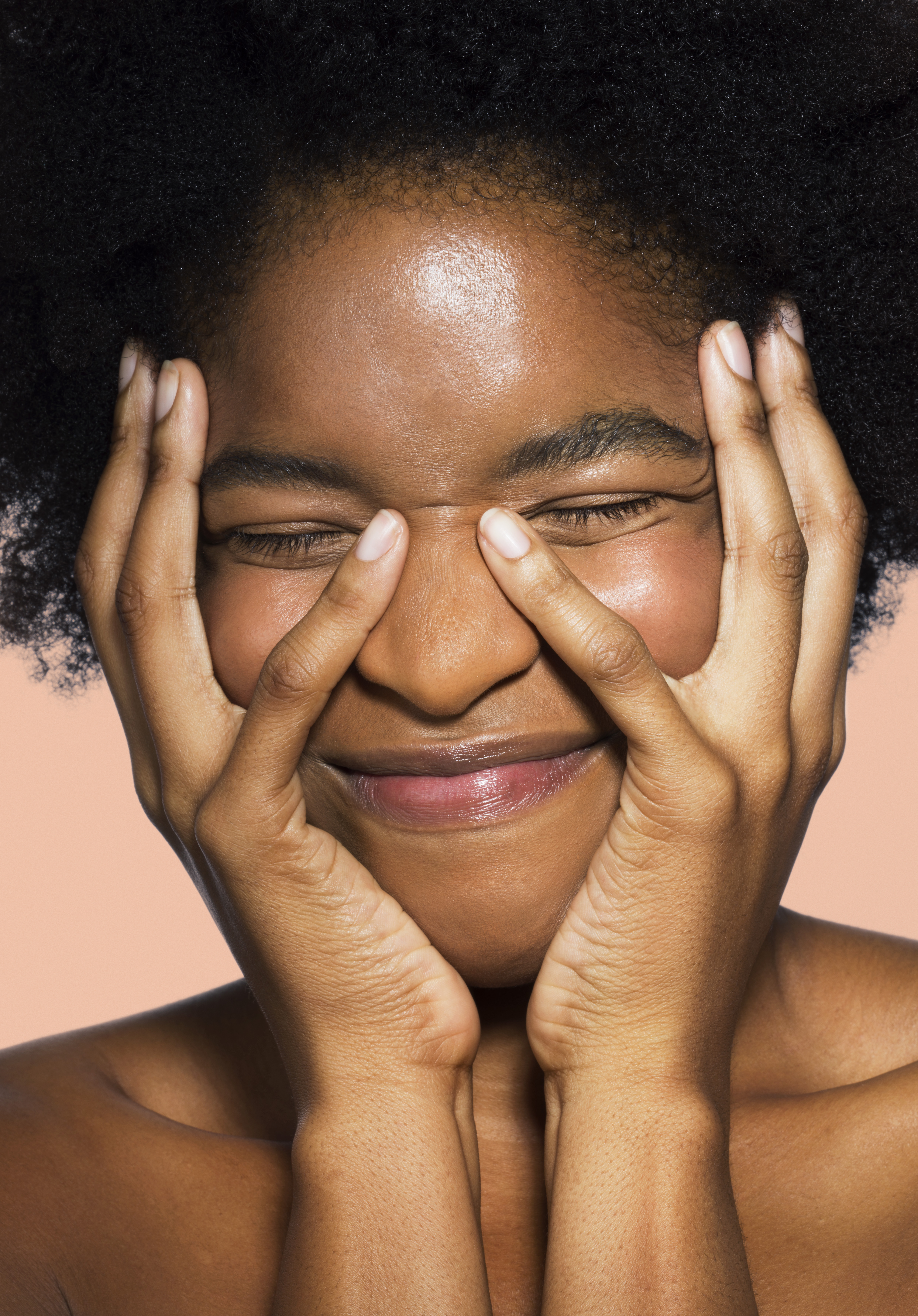 Close-up of young female face with hands