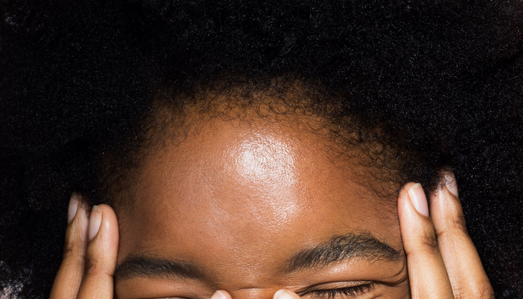 Close-up of young female face with hands