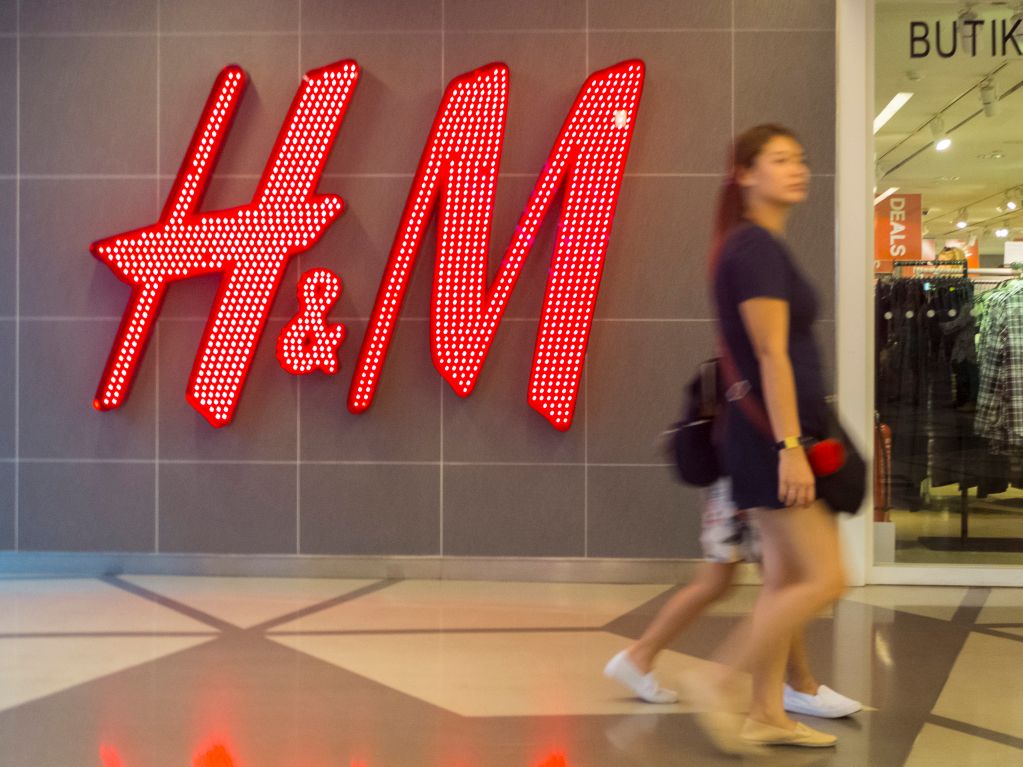 A woman seen walking in front of the H&M shop. Malaysia...
