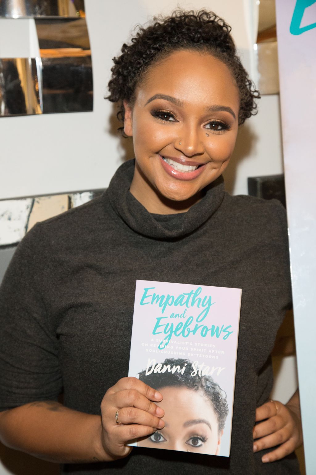 Danni Star Signs Copies Of 'Empathy And Eyebrows'
