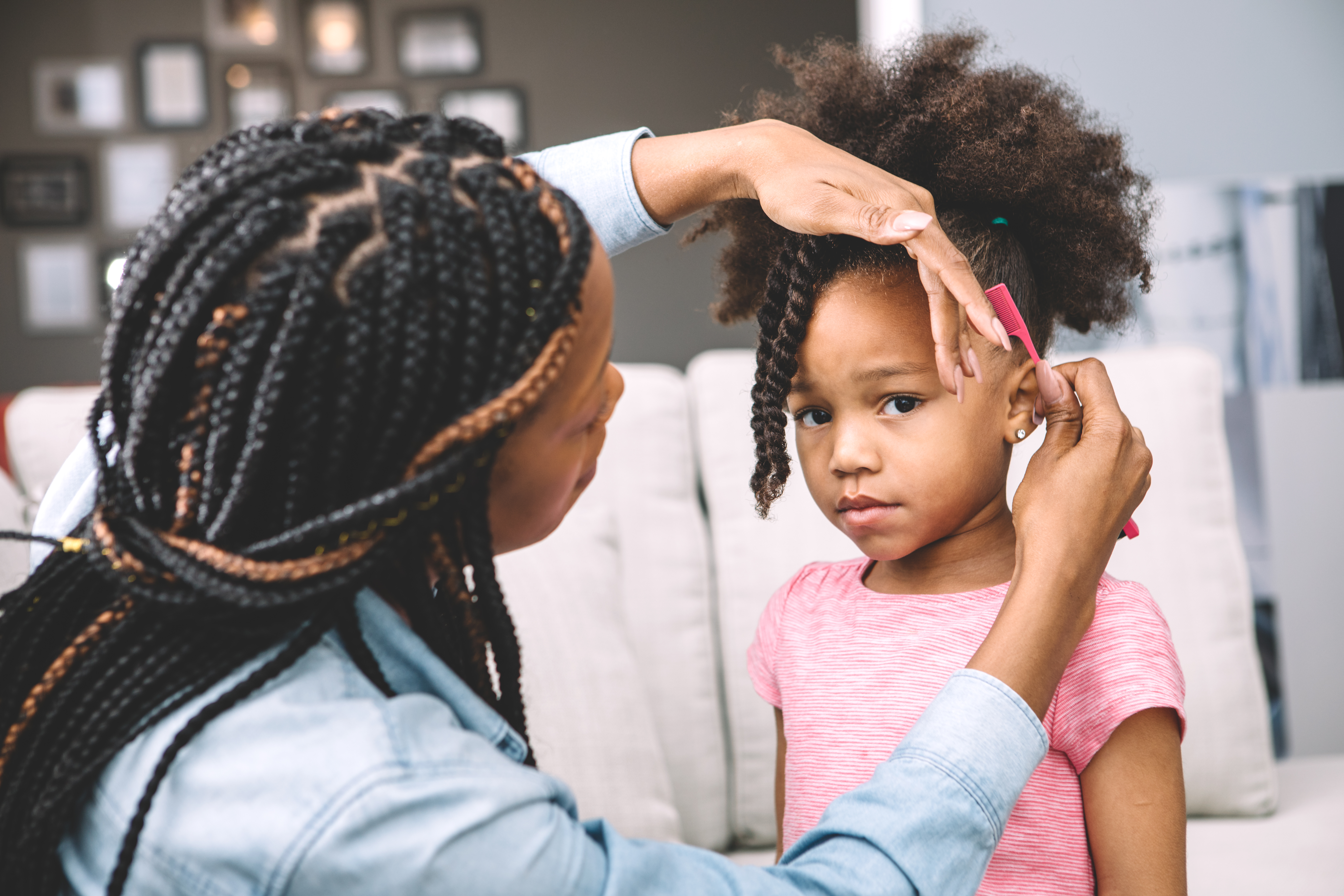 mother styling daugher's hair