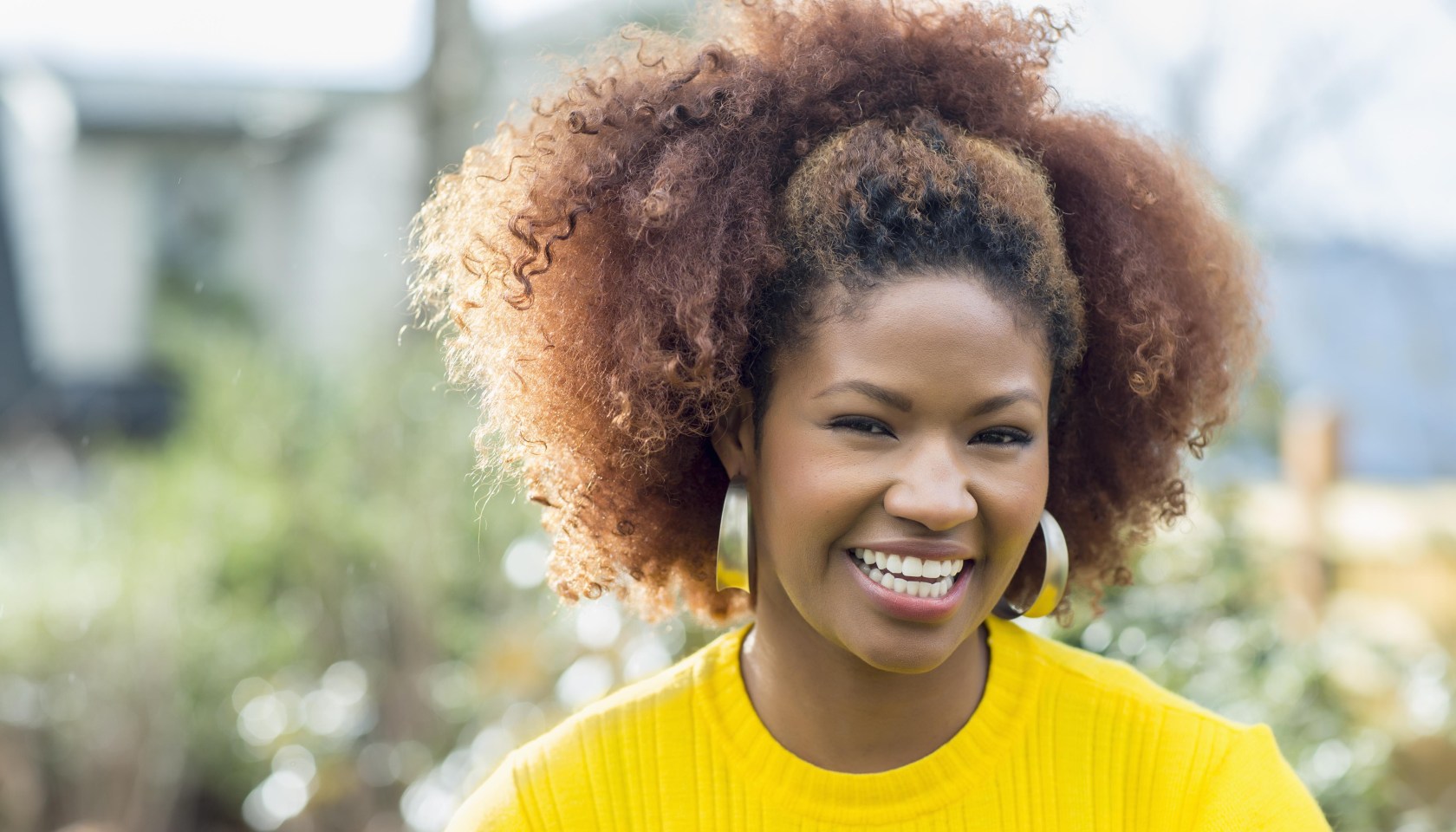 Black woman smiling outdoors