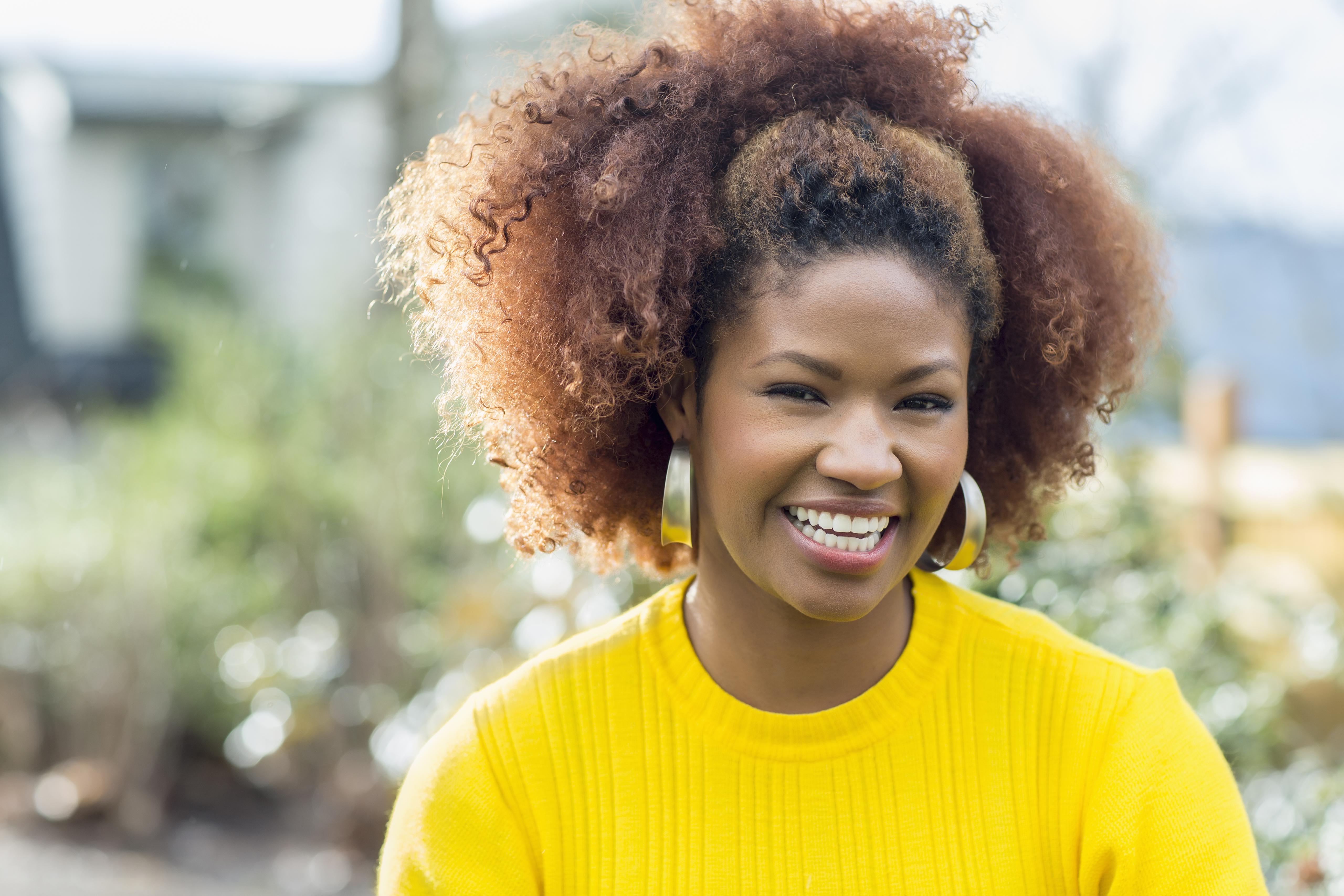Black woman smiling outdoors