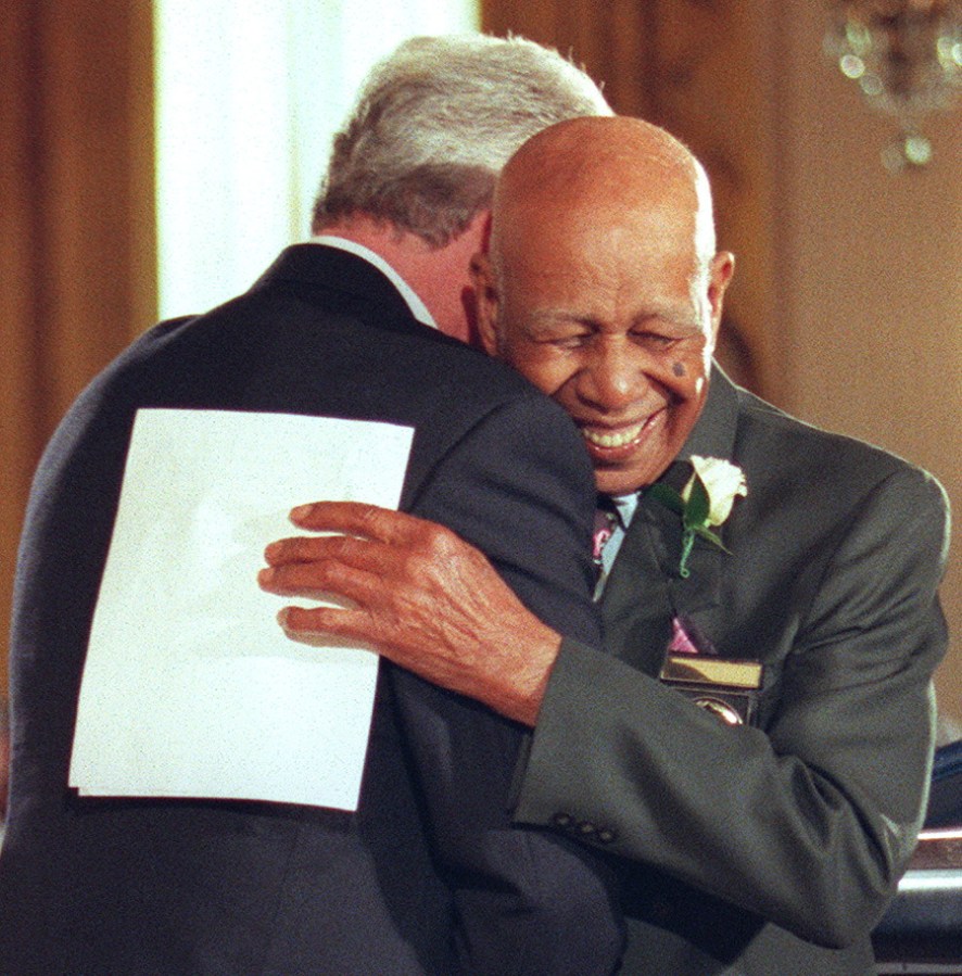Ninety-four-year-old Herman Shaw(R) embraces US Pr