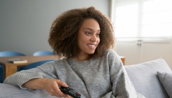 African American woman watching tv at home