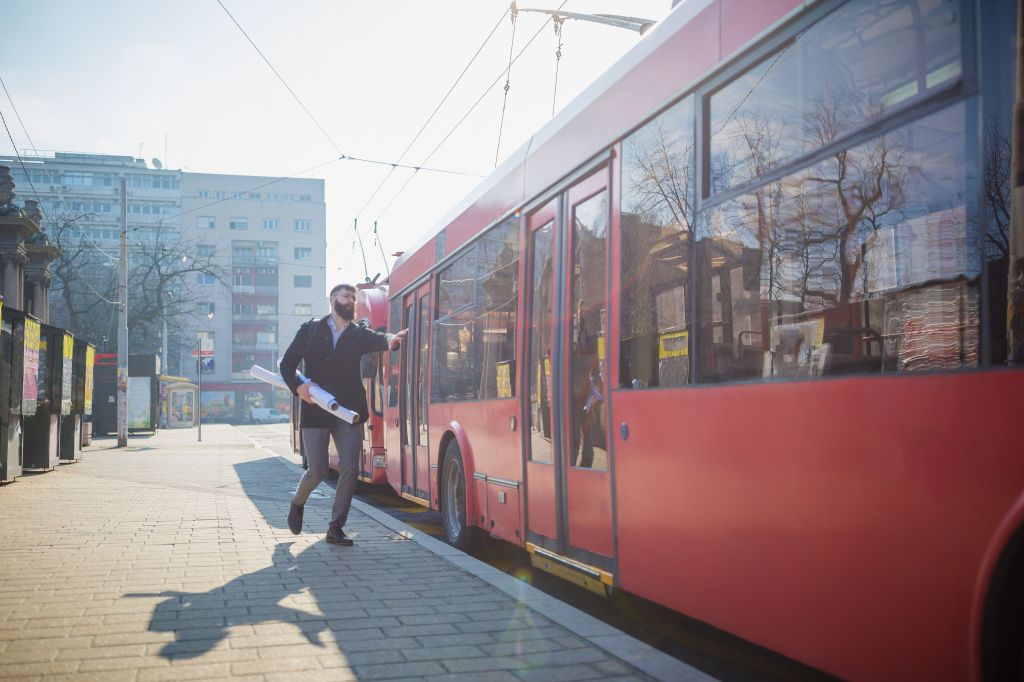 Businessman trying to catch the bus