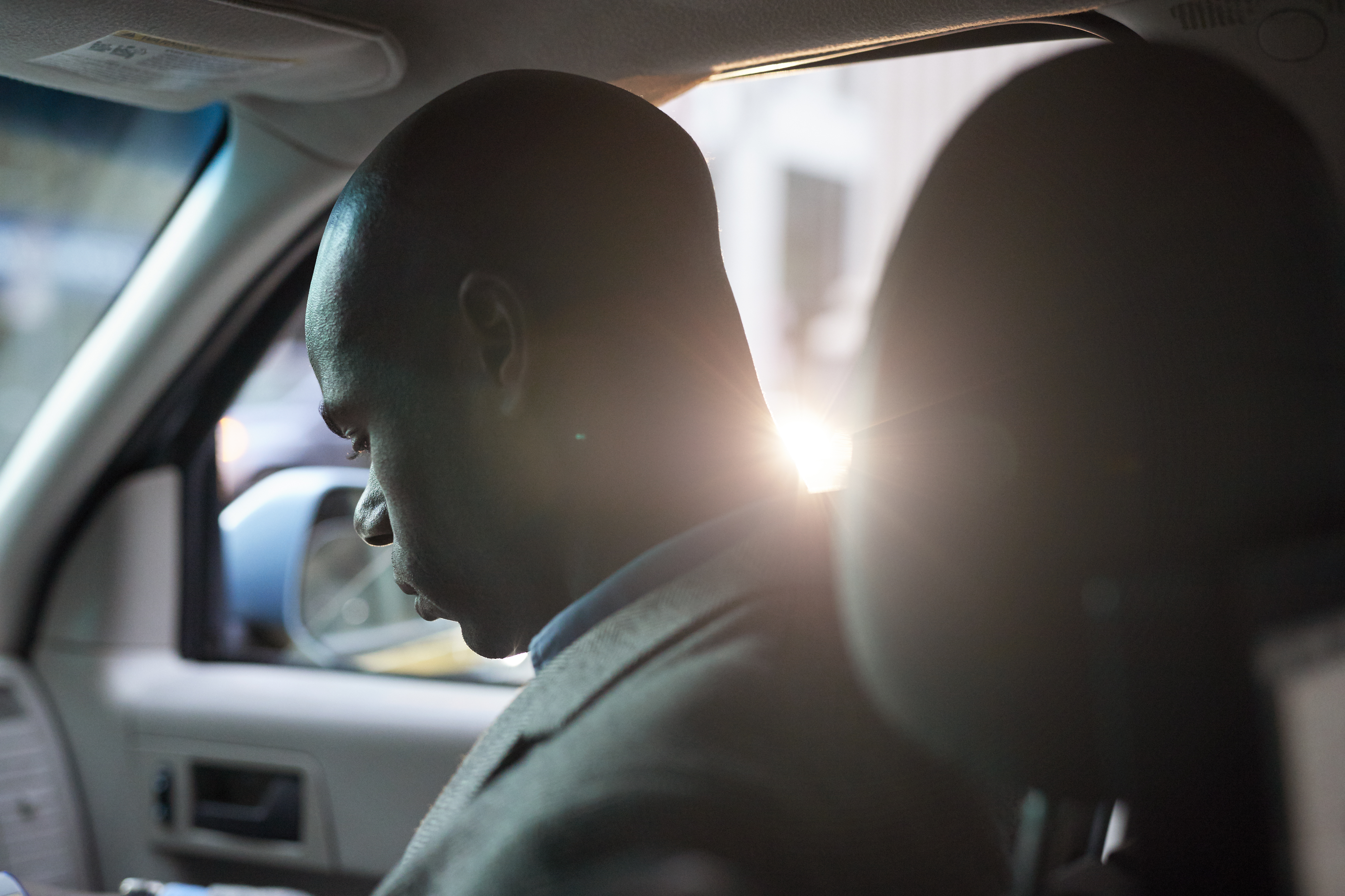 Businessman checking phone, while in a cab