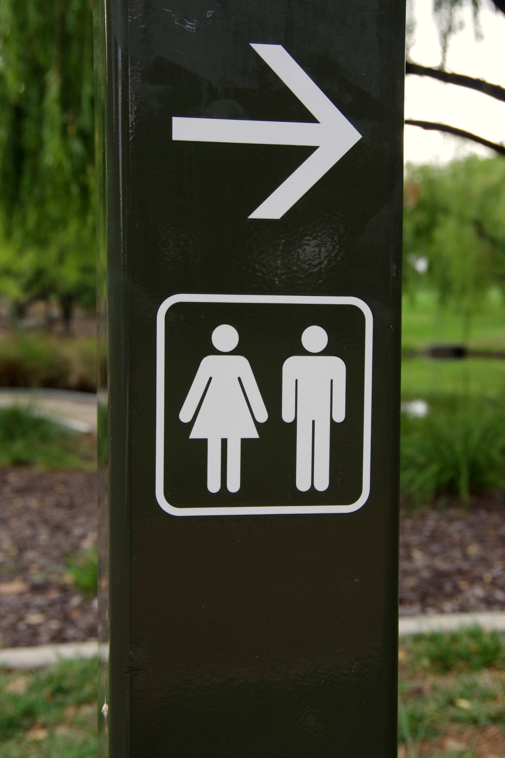 Sign post pointing to male and female public toilets in Weston Park, Yarralumla, Australian Capital Territory, Australia