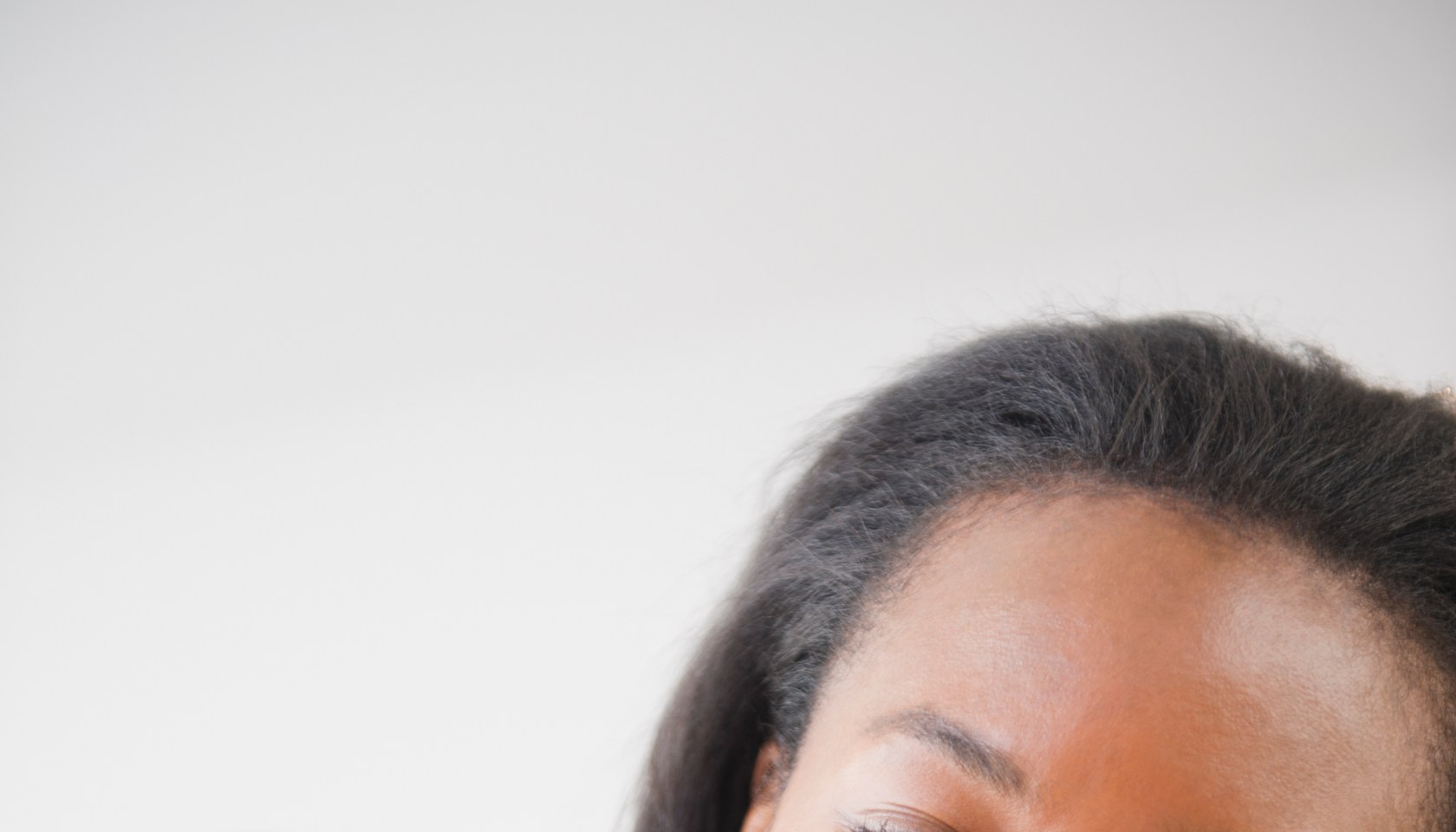 Black woman painting her fingernails
