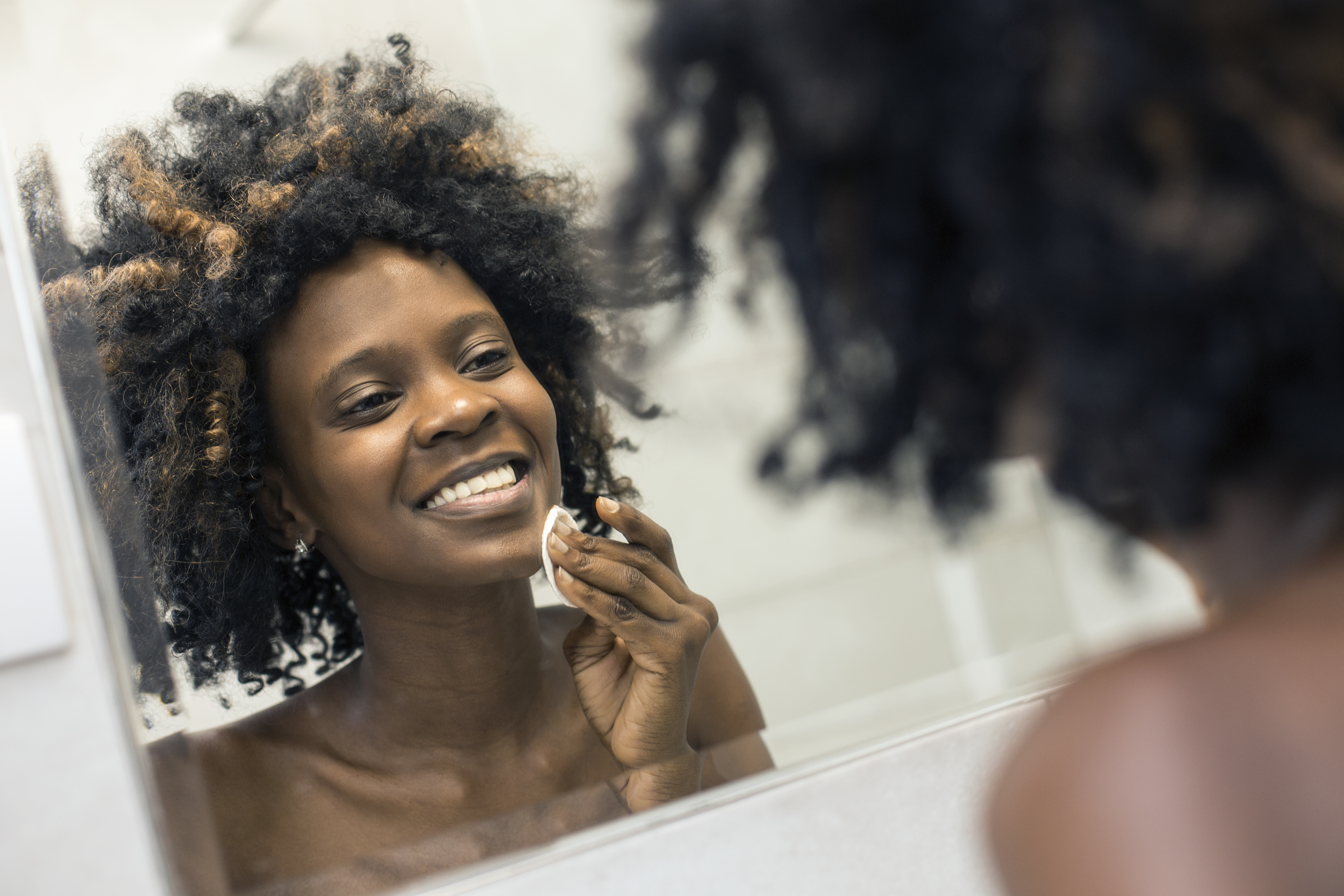 Young woman cleaning her skin