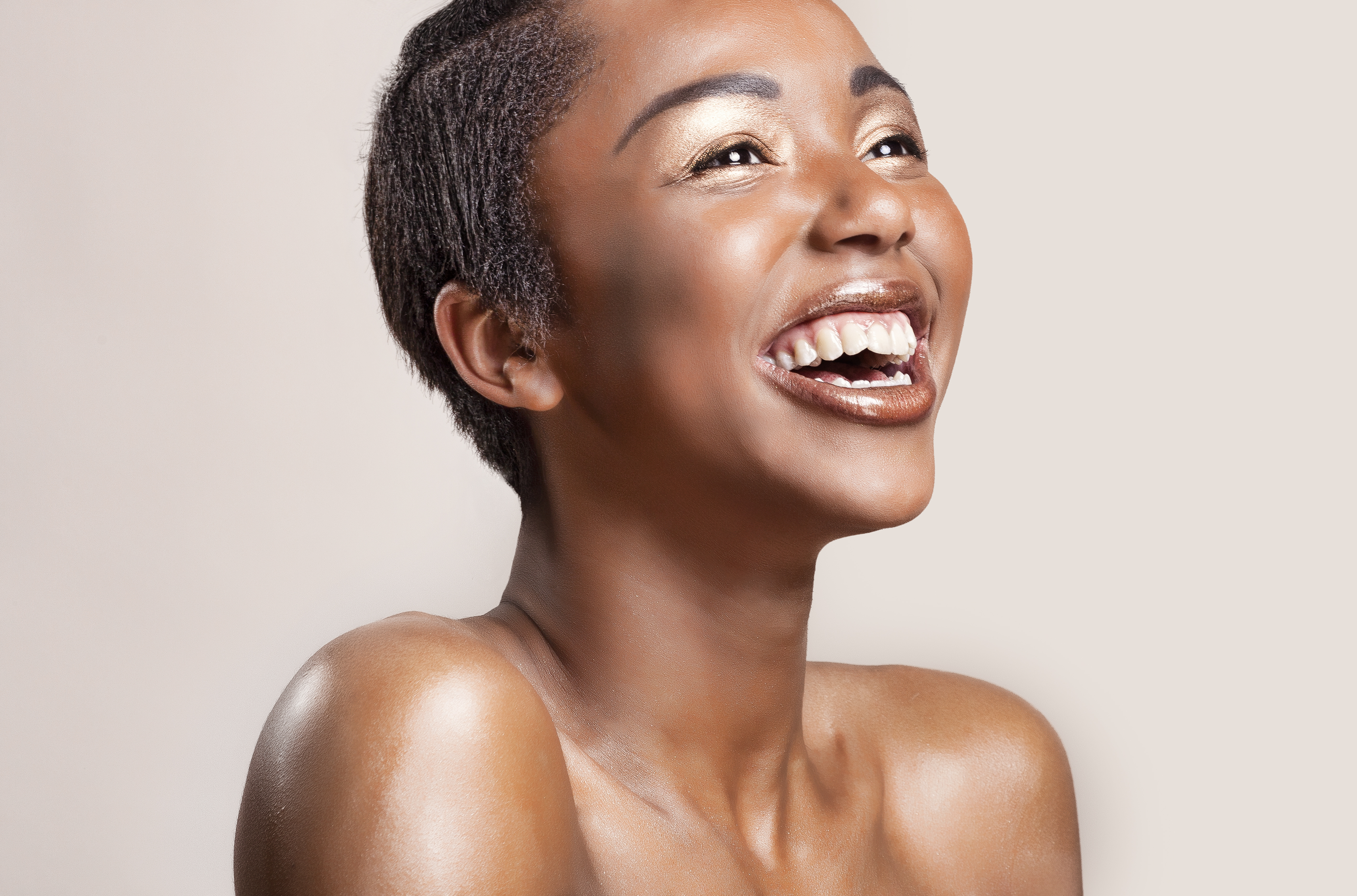 Portrait of a happy woman with glowing shiny skin