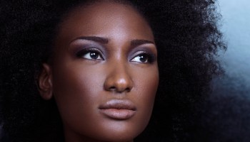 Beauty portrait of a young african american black woman face with big natural curly hair