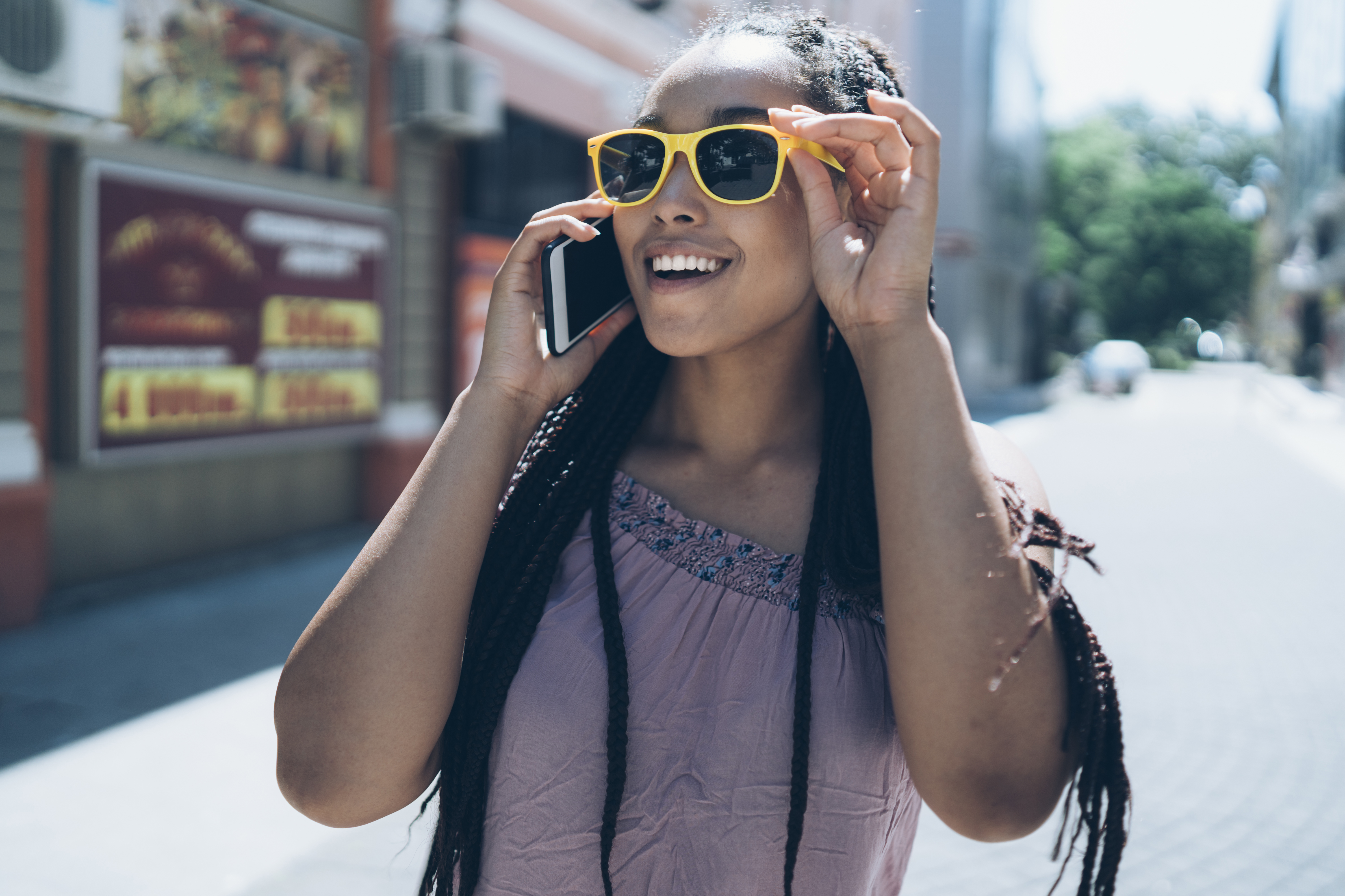 Tourist talking on phone and walking on street