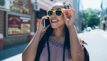 Tourist talking on phone and walking on street
