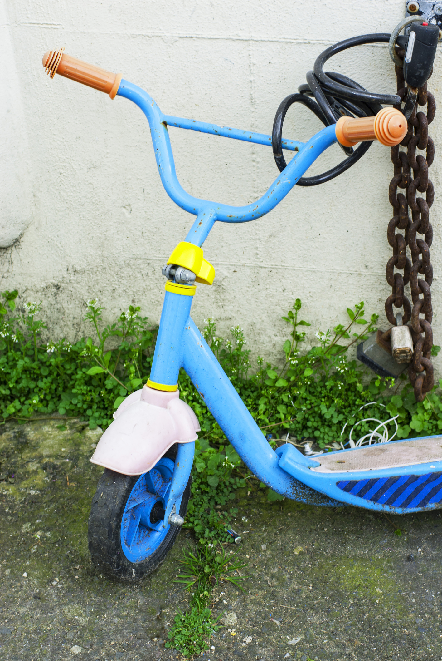 Child s scooter chained to wall