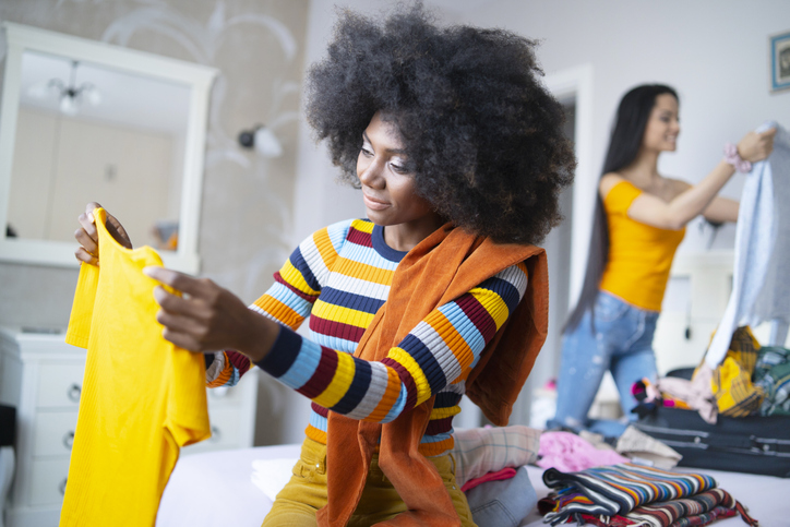 Girlfriends packing suitcases for vacations