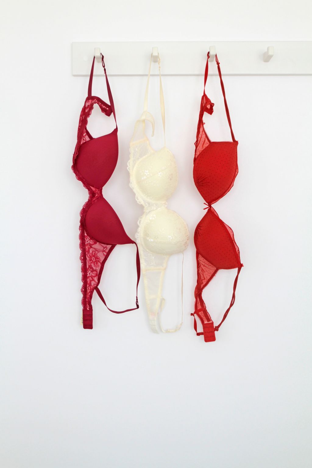 Three bras hanging on rack