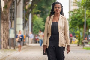 Black brazilian woman walking on the sidewalk
