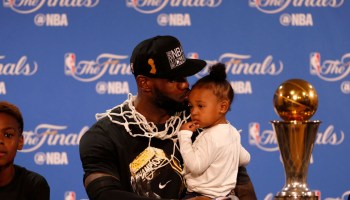 Cleveland Cavaliers' LeBron James (23) gives his daughter Zhuri Nova James a kiss during a press conference after the Cavaliers beat the Golden State Warriors in Game 7 93-89 for the NBA Finals at Oracle Arena in Oakland, Calif., on Sunday, June 19, 2016.