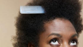 Woman looking up at comb in her hair