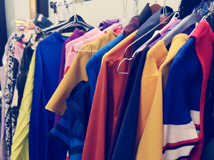 Clothes Hanging On Rack In Store For Sale