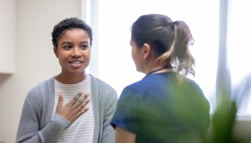 Nurse explaining good news to female patient