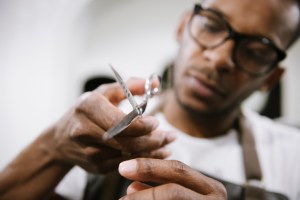 Close-up of barber holding scissors