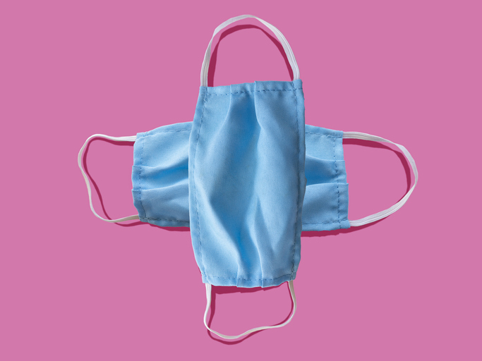Blue medical face mask to avoid contagious diseases pattern on pink background