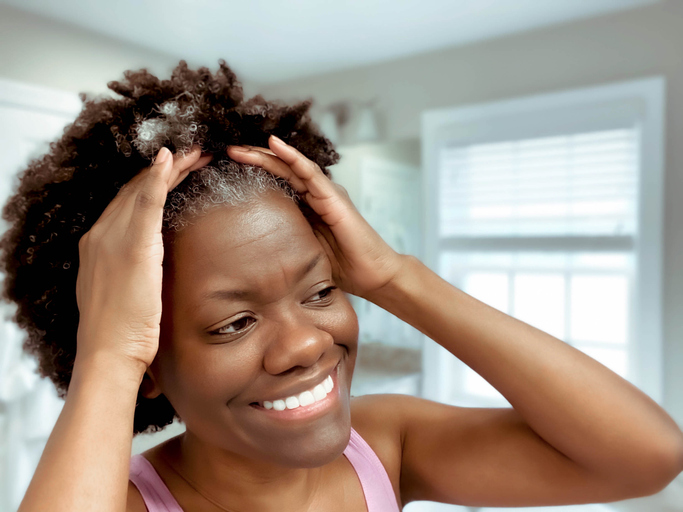 Woman Pulls Hair Back After Washing