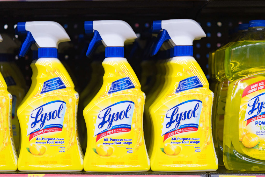 Lysol bottles on a store shelf, plastic spray bottles of all...