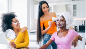 Girls taking good care of their skin and making mask