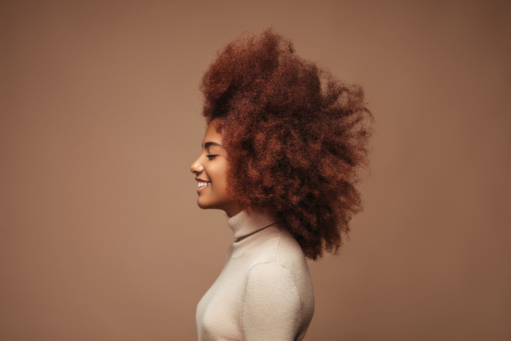 Photo of cheerful curly girl with positive emotions
