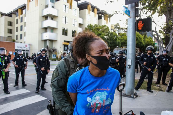 A female protester is arrested in Santa Monica during a...