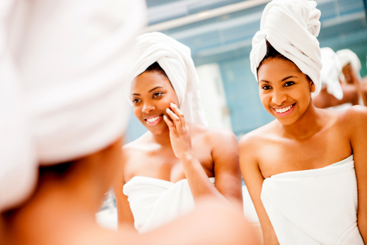 Happy black female friends having fun at a spa talking and smiling