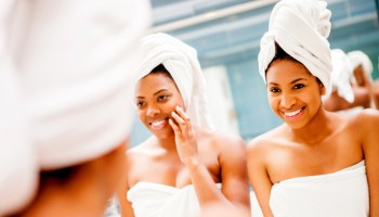 Happy black female friends having fun at a spa talking and smiling