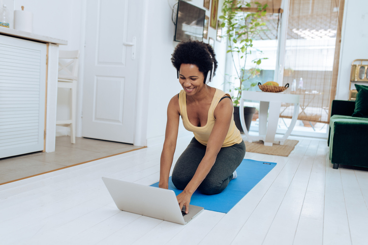 African-American yoga instructor preparing for her online class