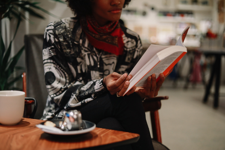 Close up image of a young black woman drinking tea in a cafe