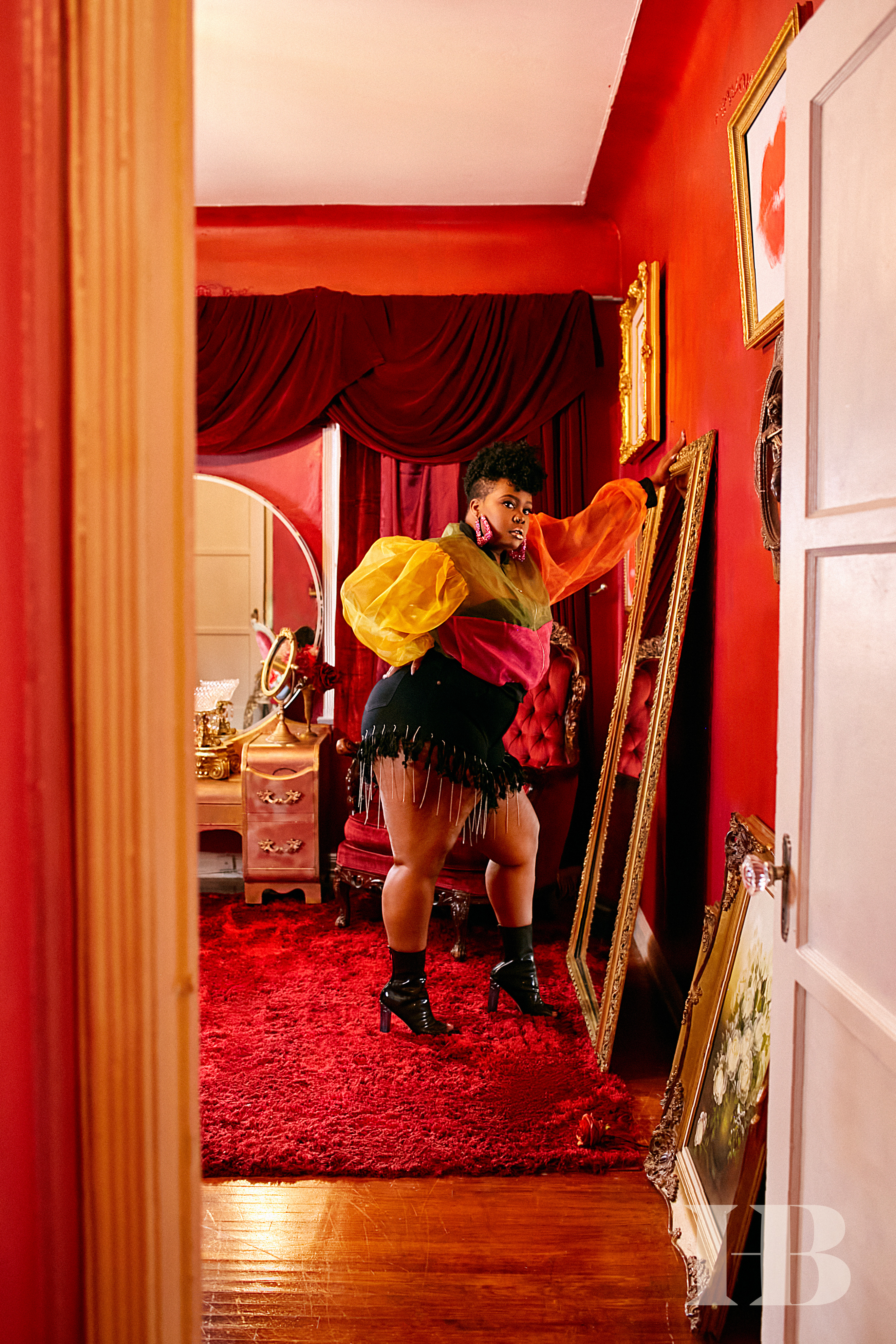 Amber Riley posing in front of a full-length mirror.