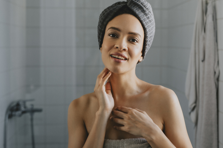Beautiful African American Woman Wrapped in a Towel after Having a Shower