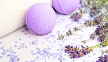 Lavender flowers and beauty products isolated on white background.