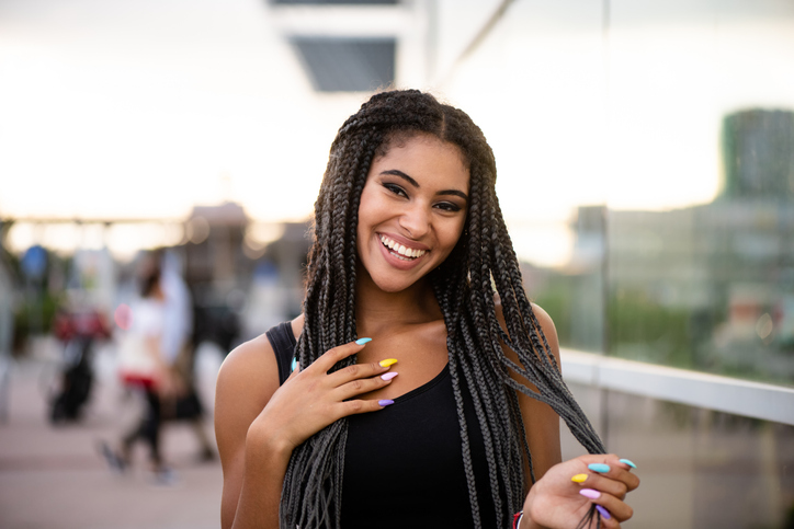 Fashionable young model with colorful nail paint