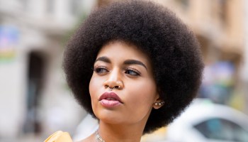 Afro woman contemplating outdoors