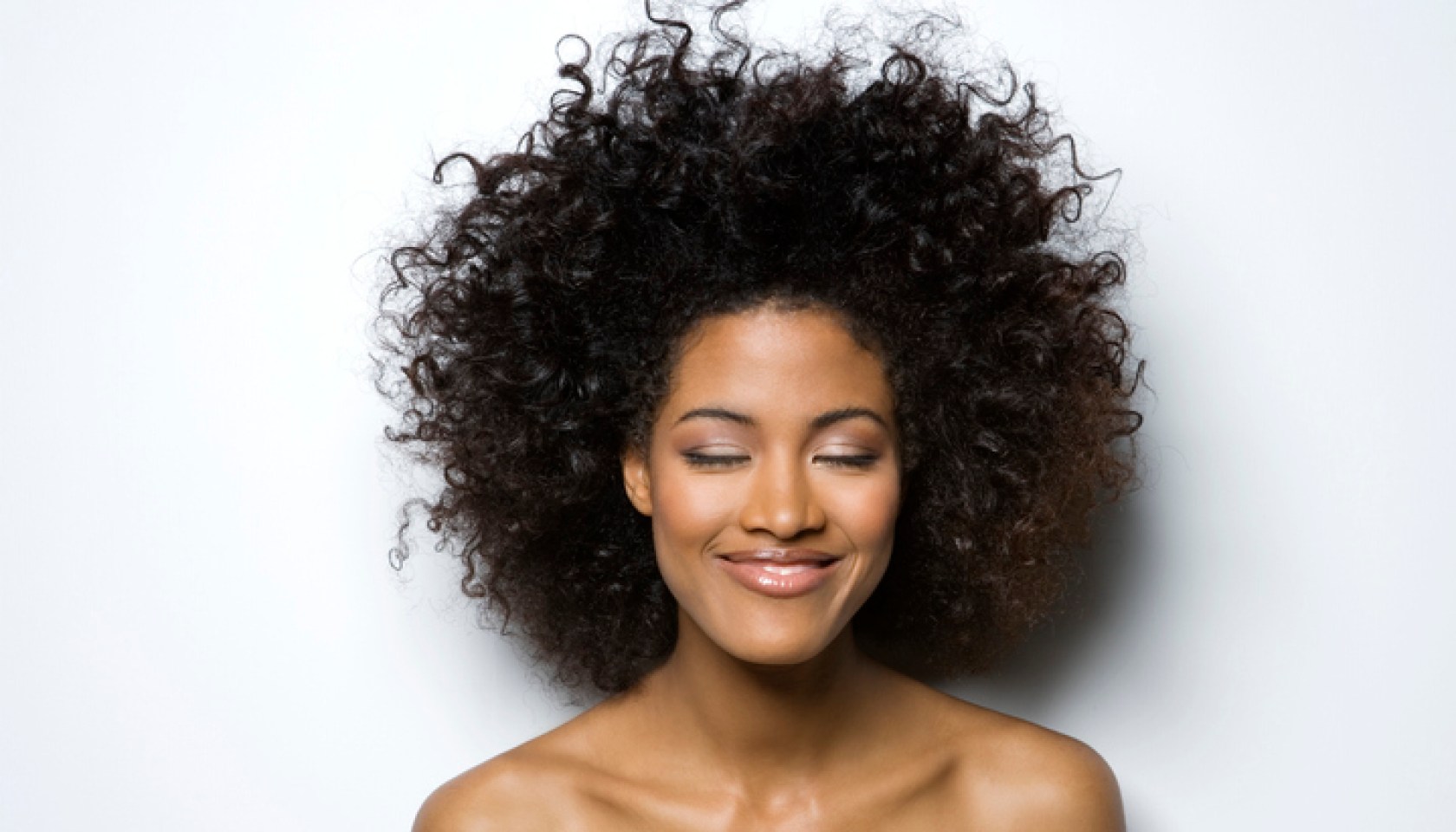 Young woman with eyes closed, smiling, close-up