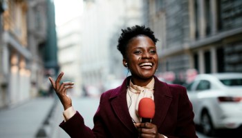 African female news reporter in live broadcasting.
