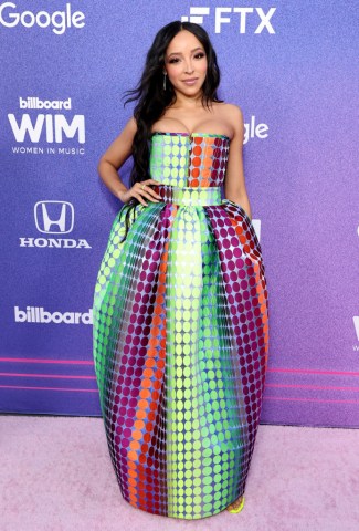 Singer Tinashe poses in a Christopher John Rogers polka dot floor length dress at the Billboard Women In Music event